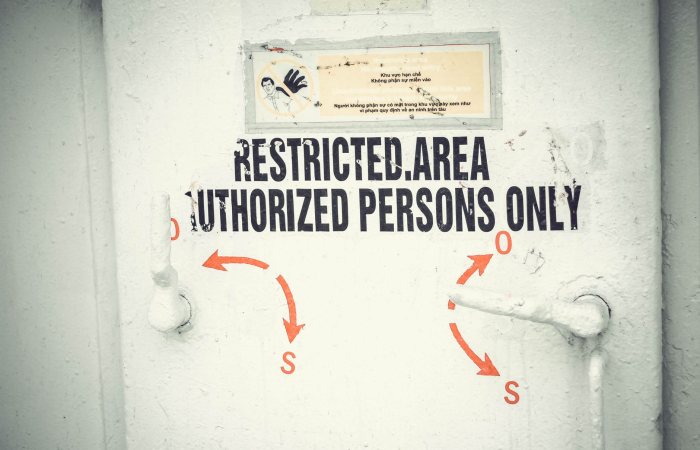 Close-up of a restricted area door with signage emphasizing authorized access only.