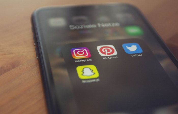 Smartphone displaying popular social media apps like Instagram, Pinterest, Twitter, and Snapchat.