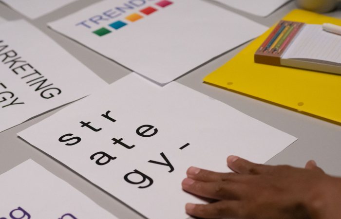 Close-up of marketing strategy notes and colorful trends sheet on a table for planning session.