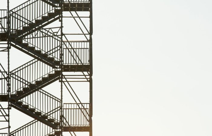 Side view of an industrial metal staircase with a minimalist design, perfect for architecture themes.