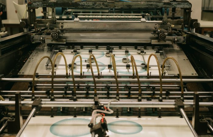 Close-up of an industrial printing press producing designs.