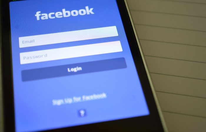 Mobile phone with Facebook login screen, highlighting digital connectivity and social media use.