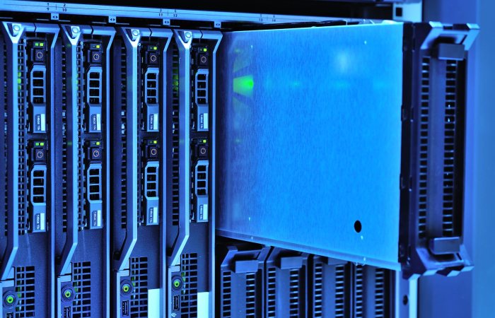 Detailed view of server racks with glowing lights in a data center environment.